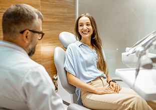 Female patient smiling at dentist at dental appointment