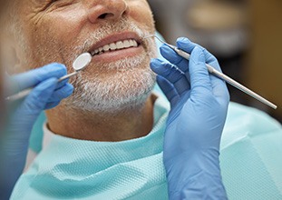Dentist pointing to model of dental implant in Raleigh, NC
