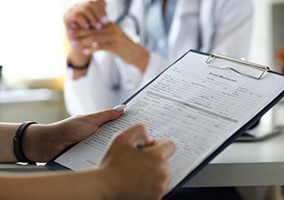 Performing surgery in order to place dental implants in North Raleigh, NC